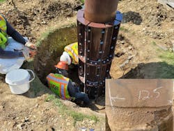 After excavation, technicians work on repairing the pole. After excavation, technicians work on repairing the pole.