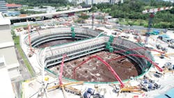 Daytime view of concrete casting process at basement 4. (Concrete pumps and trucks can be seen at ground level.) Daytime view of concrete casting process at basement 4. (Concrete pumps and trucks can be seen at ground level.)