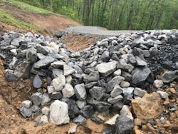 A rock check for disperses water that would run downhill and erode the mountainside if not interrupted. The image was stored as a Best Management Practice in the software system. A rock check for disperses water that would run downhill and erode the mountainside if not interrupted. The image was stored as a Best Management Practice in the software system.