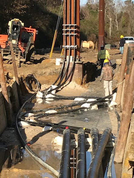 The area from the end of the HDD ducts to the base of the termination pole was directly buried, and an S-bend was placed in the excavation to allow termination replacement if needed, without having to install a splice.