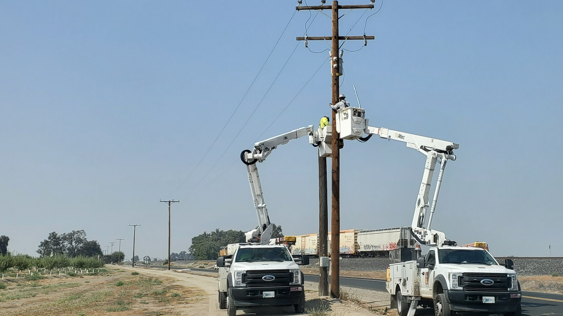Southern California Edison work crews install radio gear to distribution line.
