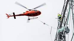 Statnett line worker installs 420-kV insulators aided by helicopter. Statnett line worker installs 420-kV insulators aided by helicopter.
