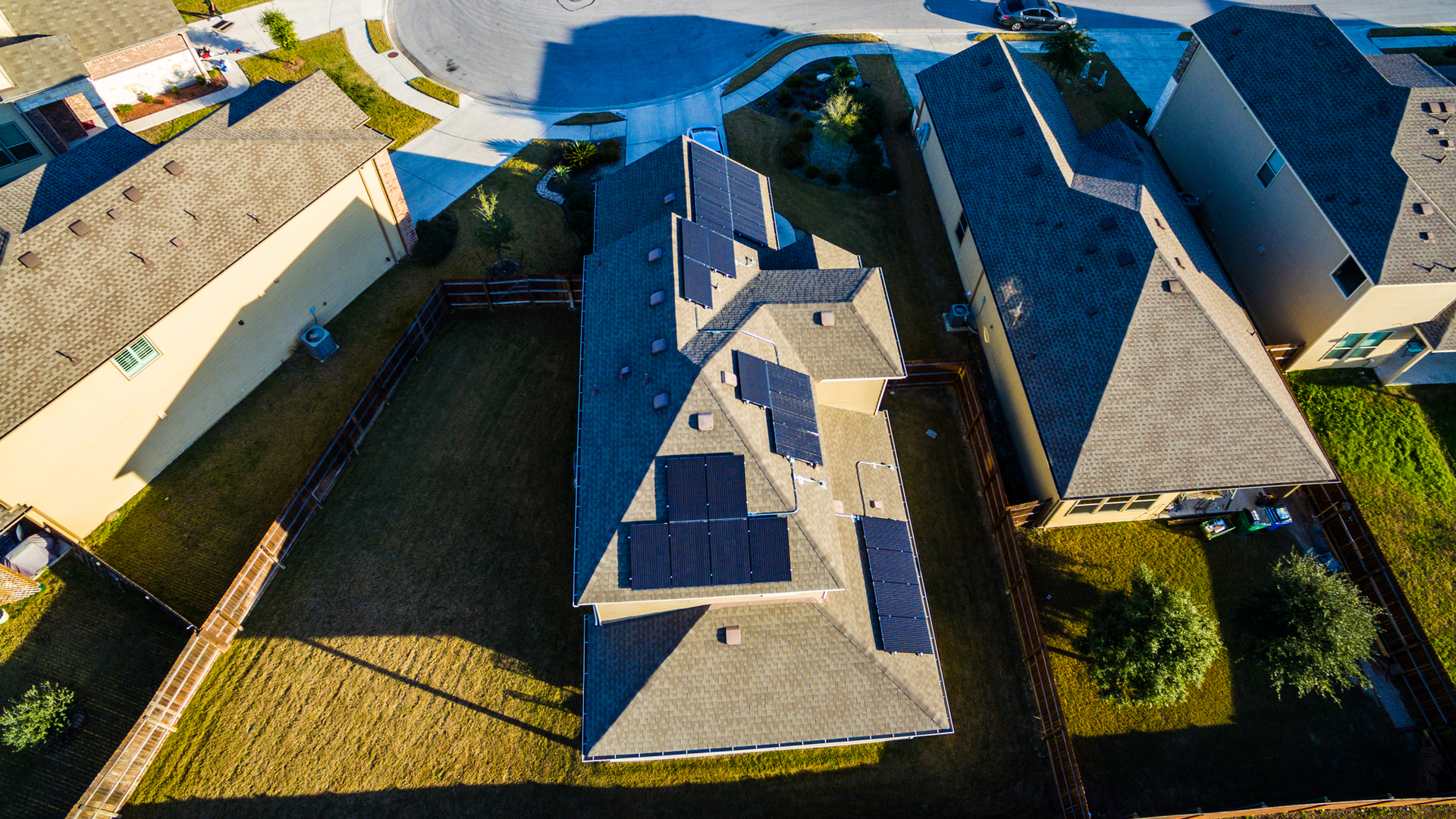 Rooftop solar installations in a residential area. A DERMS provides centralized monitoring and control of DERs connected to a distribution grid by forecasting, monitoring and managing the operation of each DER to satisfy operating and business objectives.