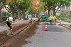 Crews cut into a residential street to lay underground lines for street lights in Alameda, California. In California, utilities are committing to multi million dollar undergrounding projects as a way to prevent wildfires sparked by overhead transmission and distribution.