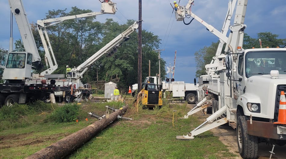 Jo-Carroll Energy crews performing maintenance on overhead lines.