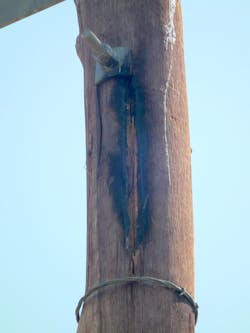 Wood pole splintered and burnt in insulation coordination gap because of suspected repeated lightning flashover and resulting power frequency follow-through current. Wood pole splintered and burnt in insulation coordination gap because of suspected repeated lightning flashover and resulting power frequency follow-through current.