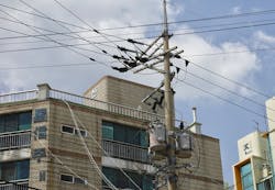 Power pole with distribution lines and overhead transformers at Jeju Island. The island is South Korea's most populous island, and constitutes its own self-governing province. Power pole with distribution lines and overhead transformers at Jeju Island. The island is South Korea's most populous island, and constitutes its own self-governing province.
