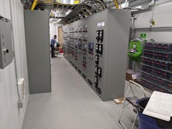 Control and protective relays and other control equipment can be seen to the left. On the right is a partial view of the significant 125 VDC station battery, power plant. It supplies the continuous DC power needed by the controls during some transmission disturbances. This is part of a redundant plant for reliability.