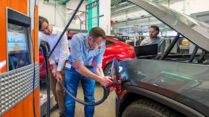 Representatives from Shell Global Solutions work with automaker Rivian to gather data on establishing a secure and encrypted connection between a charging station and an electric vehicle.