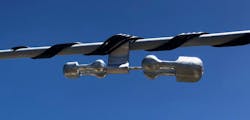 Installed spiral vibration dampener. Proper interfacing and compatibility with the covered conductor were vital considerations. Installed spiral vibration dampener. Proper interfacing and compatibility with the covered conductor were vital considerations.