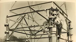 In the early days, lineworkers erected a lattice tower without the heavy equipment line crew have access to today.