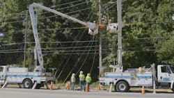 Line worker disconnects overhead power lines in Ben Hill Park area, where neighborhood power lines were placed underground to help make grid more resilient in area prone to damage by vegetation and traffic accidents. Photo by Georgia Power. Line worker disconnects overhead power lines in Ben Hill Park area, where neighborhood power lines were placed underground to help make grid more resilient in area prone to damage by vegetation and traffic accidents. Photo by Georgia Power.