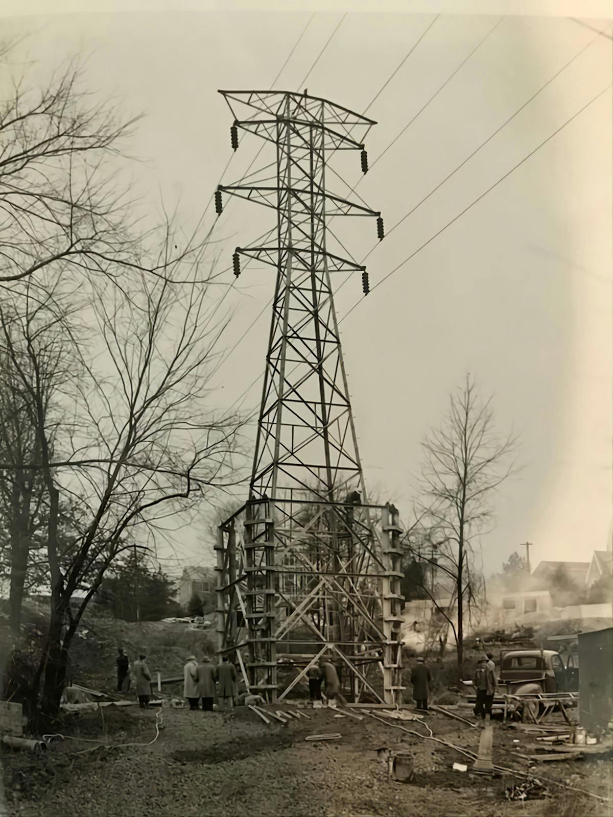 In the early days, lineworkers erected a lattice tower without the heavy equipment line crew have access to today.