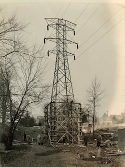 In the early days, lineworkers erected a lattice tower without the heavy equipment line crew have access to today. In the early days, lineworkers erected a lattice tower without the heavy equipment line crew have access to today.