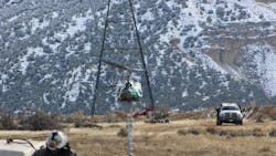 As part of his job, Kelly Steber works alongside helicopter crews for line work. As part of his job, Kelly Steber works alongside helicopter crews for line work.