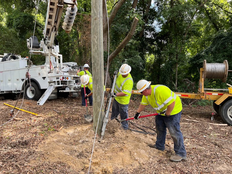 JOEMC workers put a utility pole into place. The co-op employs 183 people, about 90 of whom account for outside line workers who handle a myriad of tasks, including vegetation management and line construction and maintenance.