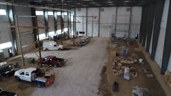 The training center, shown here under construction, includes a set of 115kV H frame structures, a 69kV substation and would eventually feature a set of 69kV structures along the right side of the facility that would connect into the substation. The facility is connected to a conference room and substation panel that can be accessed through the door, seen here in the back left of the photo The training center, shown here under construction, includes a set of 115kV H frame structures, a 69kV substation and would eventually feature a set of 69kV structures along the right side of the facility that would connect into the substation. The facility is connected to a conference room and substation panel that can be accessed through the door, seen here in the back left of the photo