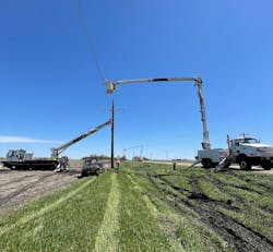 Pole is plumbed with help from multiple bucket trucks in Agralite Electric Cooperative area, northwest of Benson, Minnesota. Pole is plumbed with help from multiple bucket trucks in Agralite Electric Cooperative area, northwest of Benson, Minnesota.