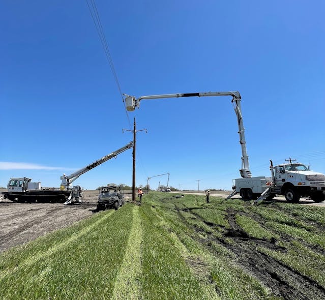 Pole is plumbed with help from multiple bucket trucks in Agralite Electric Cooperative area, northwest of Benson, Minnesota.