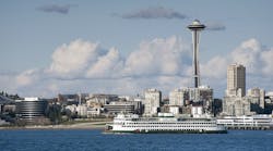 A ferryboat passes by the Seattle waterfront on the way to Bainbridge Island. The Space Needle can be seen in the background.