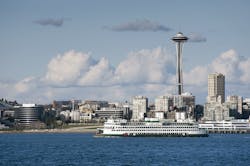 A ferryboat passes by the Seattle waterfront on the way to Bainbridge Island. The Space Needle can be seen in the background. A ferryboat passes by the Seattle waterfront on the way to Bainbridge Island. The Space Needle can be seen in the background.