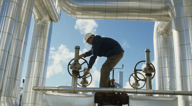 A worker adjusts valves at a California solar thermal power plant.