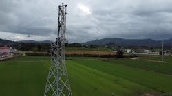 Steel lattice tower being assembled in the rural section of overhead line. Steel lattice tower being assembled in the rural section of overhead line.