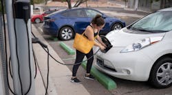 Kaedi Sanchez plugs in her car at a City of Albuquerque electric vehicle charger before heading to work. Sandia National Laboratories researchers have been studying the vulnerabilities of electric vehicle charging infrastructure, including public chargers, to better inform policymakers.