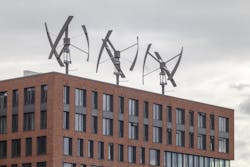 Vertical axis wind turbines arrayed on a piece of commercial real estate in Germany. Vertical axis wind turbines arrayed on a piece of commercial real estate in Germany.