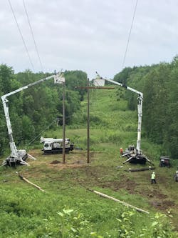 Great River Energy line crews work to restore poles damaged during storm. Great River Energy line crews work to restore poles damaged during storm.