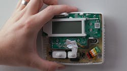 A Sensi smart thermostat being installed. A Sensi smart thermostat being installed.