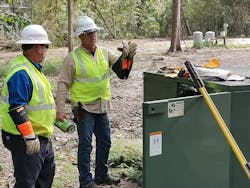 From left to right: Trouble technicians David Hines and Mike Haworth from Duke Energy’s Ocala Operations Center in Florida check a fuse in a local neighborhood while restoring power following Hurricane Nicole. From left to right: Trouble technicians David Hines and Mike Haworth from Duke Energy’s Ocala Operations Center in Florida check a fuse in a local neighborhood while restoring power following Hurricane Nicole.