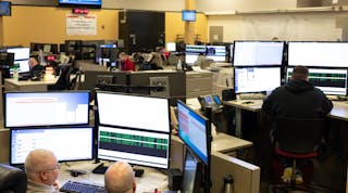 Alabama Power dispatch center personnel monitoring infrastructure and potential outages.