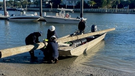 Dominion Energy South Carolina crew members from the Mount Pleasant operations center work to ensure the safe transport of equipment and a 40-foot, Class 4 wooden pole as they prepare to launch from a nearby marina on Isle of Palms, S.C.