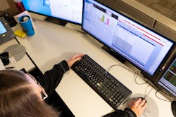 A dispatch coordinator scrolls crew rosters, while scanning outage management system. A dispatch coordinator scrolls crew rosters, while scanning outage management system.
