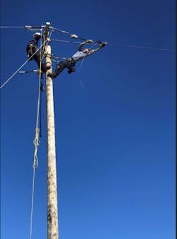 Dominion Energy South Carolina apprentice linemen Timothy Wall and Josh Novak work to sag the conductor across the river.