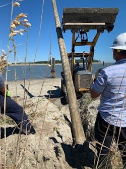 Dominion Energy South Carolina line Supervisor Chuck Howard directs Sean Garvin, journeyman lineman, in setting the new pole using a backhoe on loan from the Dewees Island Maintenance Dept. Dominion Energy South Carolina line Supervisor Chuck Howard directs Sean Garvin, journeyman lineman, in setting the new pole using a backhoe on loan from the Dewees Island Maintenance Dept.