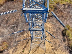 Overhead view of metal transmission tower surrounded by scorched earth. Overhead view of metal transmission tower surrounded by scorched earth.