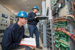 Utility substation technicians performing routine maintenance. Utility substation technicians performing routine maintenance.