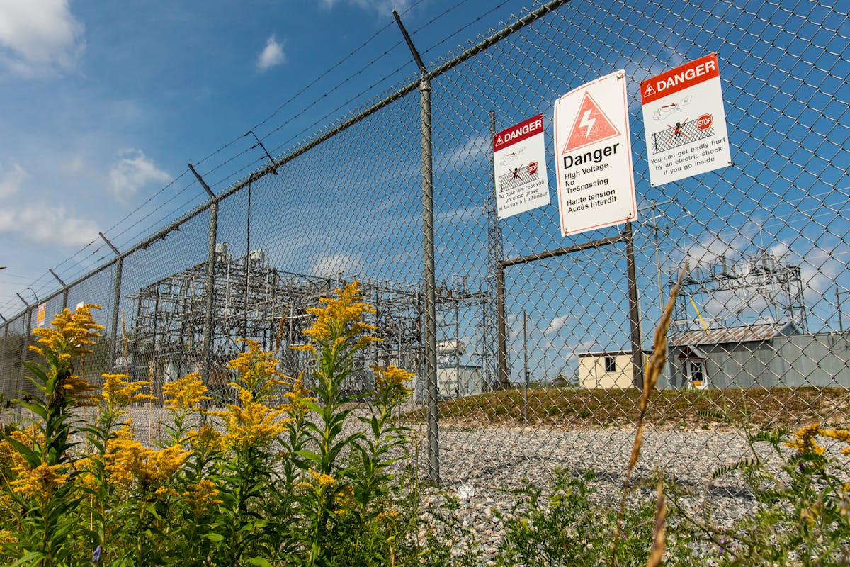 Warning signs at a substation in Quebec, Canada, announce the dangers within in both French and English.