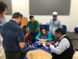 At a tree biomechanics workshop in Guadalajara, Mexico in August 2022, the group observes a fractometer, a mechanical measurement device determining characteristic values of bending and compression strength of wood evaluating samples taken from tropical ash (Fraxinus uhdei) trees.