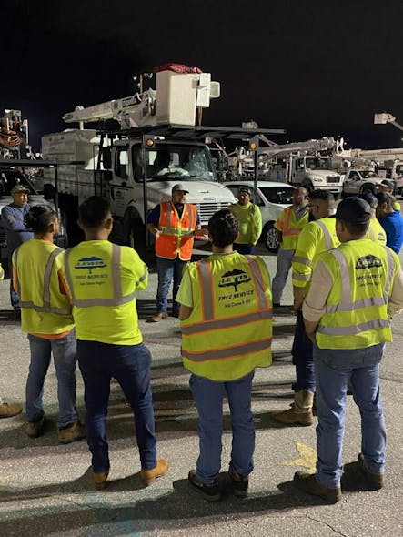 Lewis crews conduct after-action reviews in a staging area after a work day during the Hurricane Ian restoration.