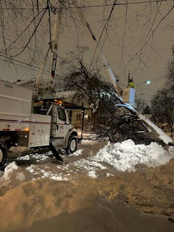A Lewis crew works in single-digit temperatures at night after Winter Storm Elliott.