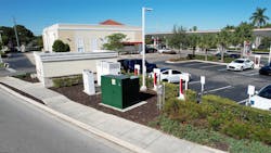 A Tesla-branded charging station center near a California shopping area. Utilities are concerned more with when EVs will pull electricity from the power grid than how much they demand.