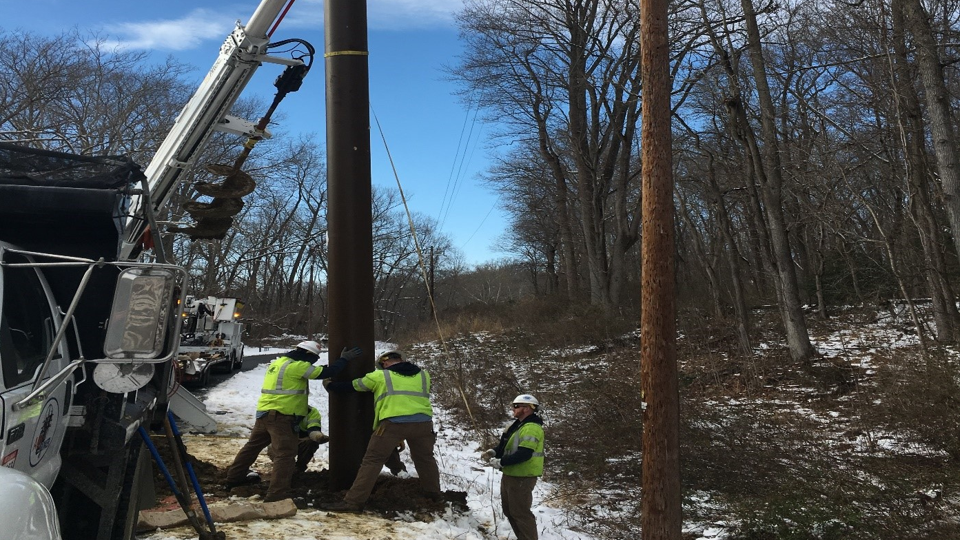 Pole base setting with line energized.