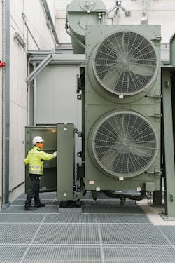 Belgium: Technician inspecting the cooler bank of one of the converter transformers. Belgium: Technician inspecting the cooler bank of one of the converter transformers.