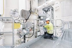 Belgium: Technician checking and locking a switch which forms part of the gas-insulated switchgear to allow safe working.