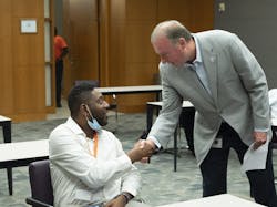 PECO President and CEO Mike Innocenzo (right, standing) greets participants in a PECO Helper Pre-Apprentice program, where workers gain instruction in safety and equipment overview. PECO President and CEO Mike Innocenzo (right, standing) greets participants in a PECO Helper Pre-Apprentice program, where workers gain instruction in safety and equipment overview.