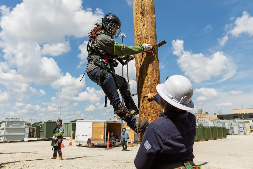 A job training participant at BGE gets utility pole climbing instruction.