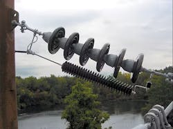 This is a detail of a lightning arrester installation at a structure with spacer cable on one side and bare conductor on the other. This is a detail of a lightning arrester installation at a structure with spacer cable on one side and bare conductor on the other.